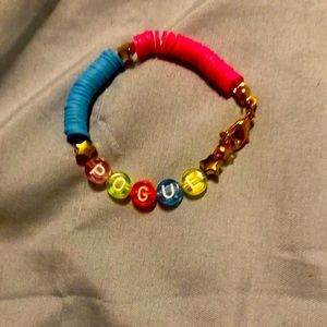 A bracelet from Outer Banks that says Pogue from the TV show Outer Banks